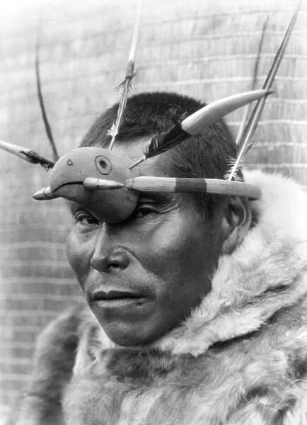ALASKA: ESKIMO MAN. A Nunivak native wearing a maskette, or headdress, with a protruding