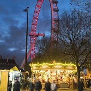 Christmas Market in Jubilee Gardens, with The London Eye at night, South Bank, London