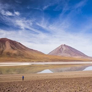 Tourists at Licancabur volcano on right and Laguna Verde, Bolivia near the border with Chile