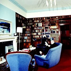 Novelist J. B. Priestley in the library of his home, Kissing Tree House